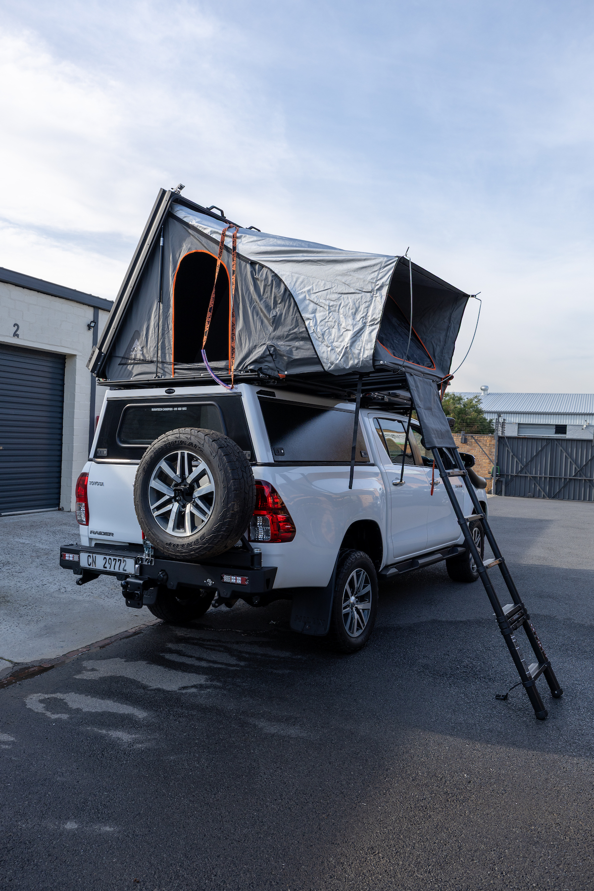 Hilux with the rooftop tent open and ladder down